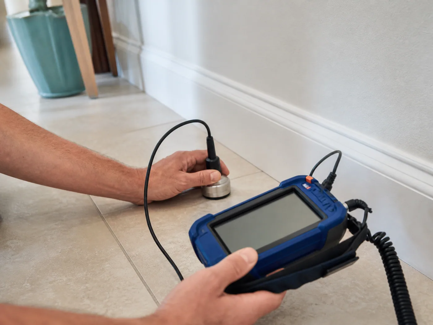 Acoustic equipment checking a tiled floor for a suspected slab leak in Baytown